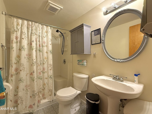 bathroom with toilet and a shower with shower curtain