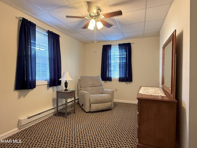 sitting room featuring a paneled ceiling, ceiling fan, a healthy amount of sunlight, and baseboard heating