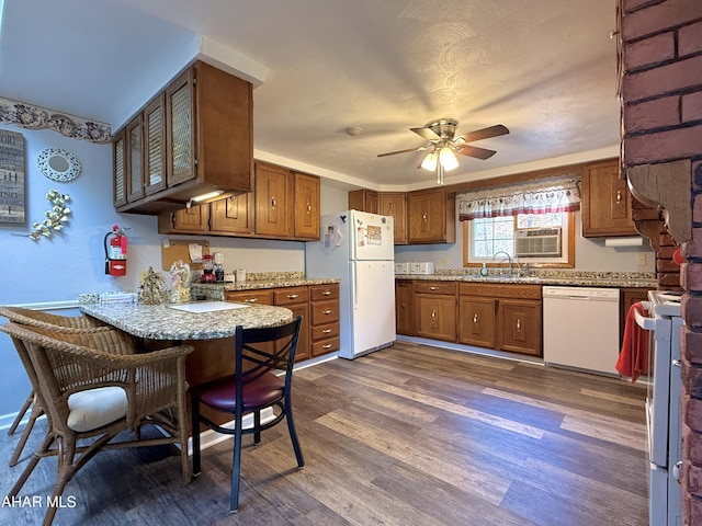 kitchen with dark hardwood / wood-style flooring, white appliances, ceiling fan, and sink