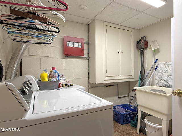 laundry area with washing machine and dryer and cabinets