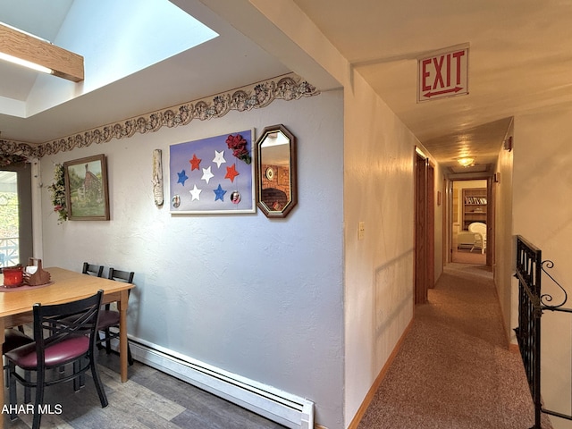 dining space featuring carpet flooring and a baseboard heating unit