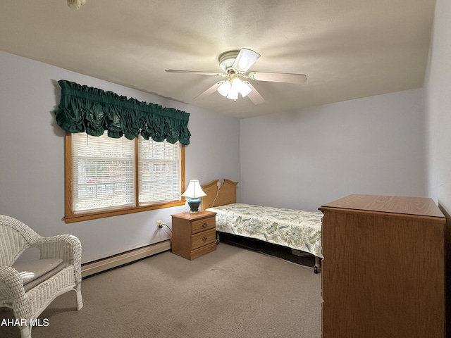 bedroom with ceiling fan, carpet, and a baseboard heating unit