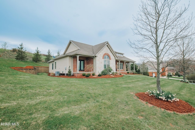 view of front facade featuring a front yard, a porch, and central air condition unit