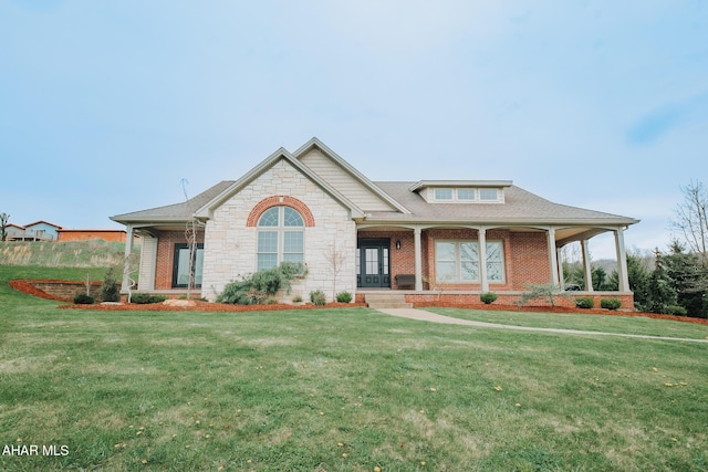 view of front of property with covered porch and a front yard