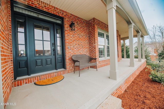 view of exterior entry featuring a porch