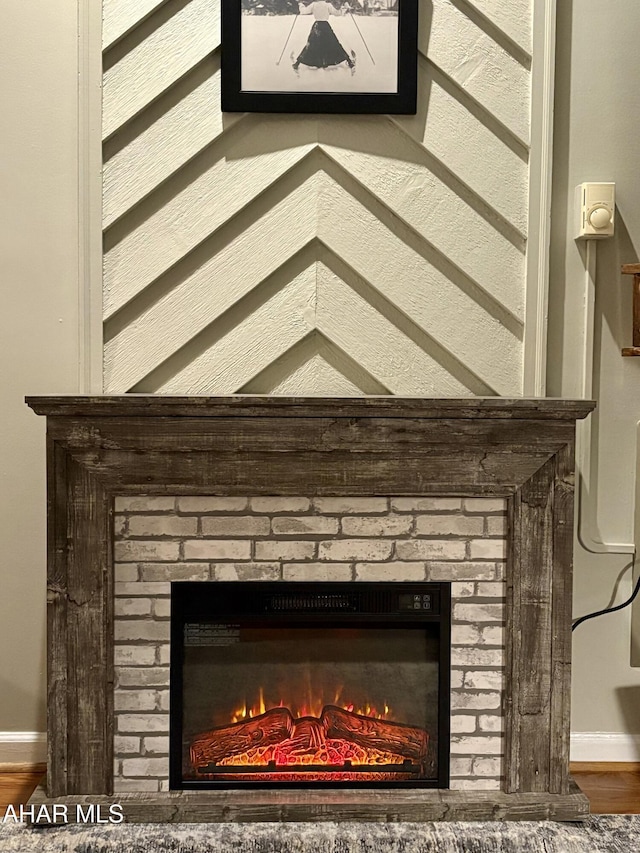 room details with wood-type flooring and a brick fireplace