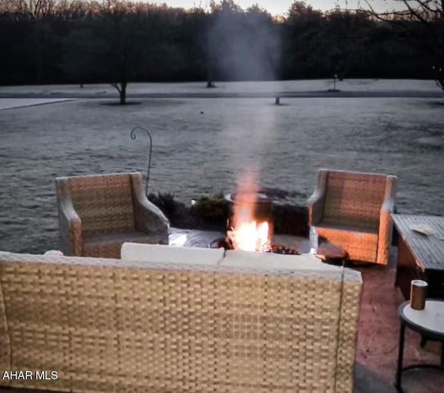 exterior space with a water view and a fire pit