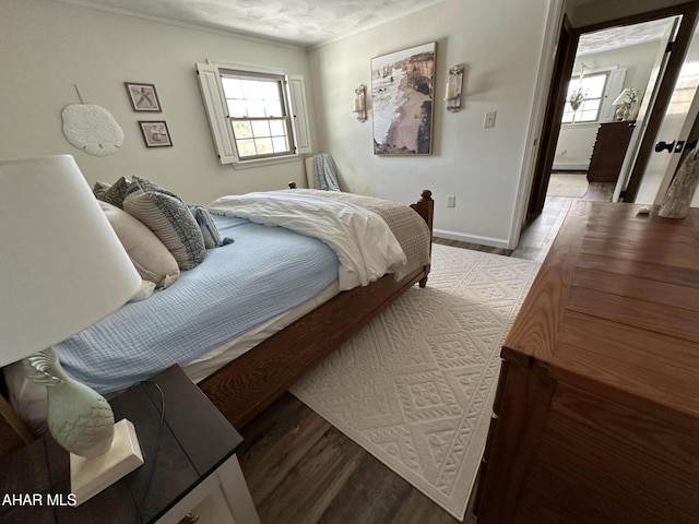 bedroom featuring multiple windows and light hardwood / wood-style floors