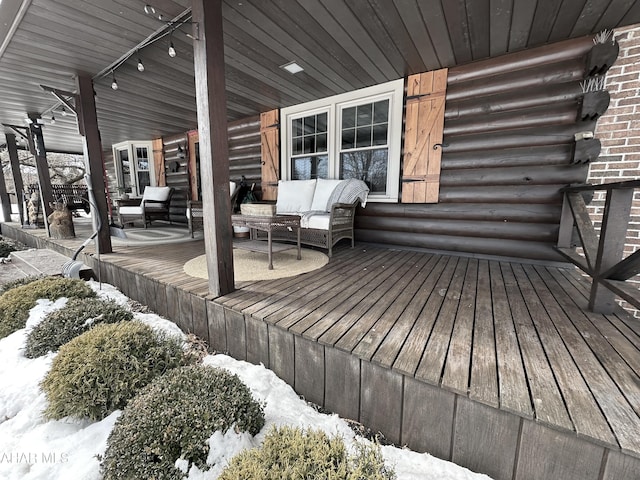 snow covered deck featuring an outdoor living space