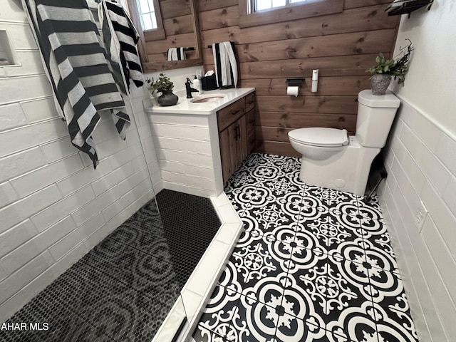 bathroom with tile patterned flooring, plenty of natural light, and walk in shower