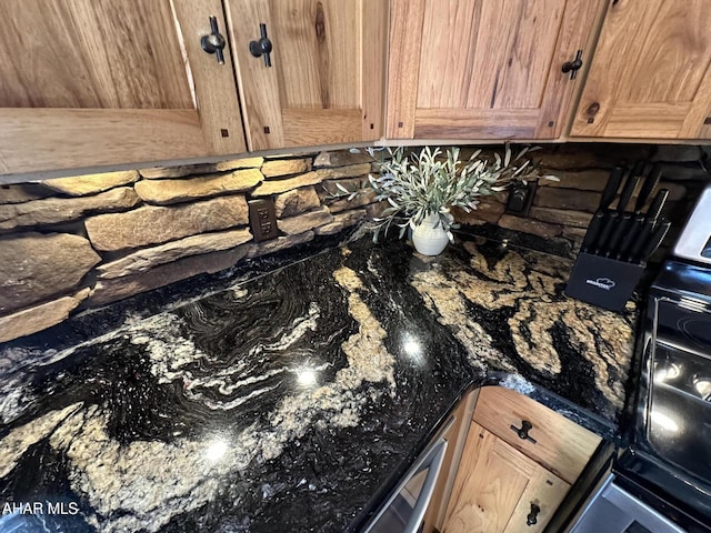 room details featuring dark stone countertops