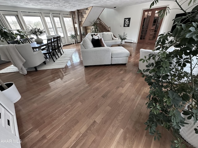 living room with hardwood / wood-style floors and a textured ceiling