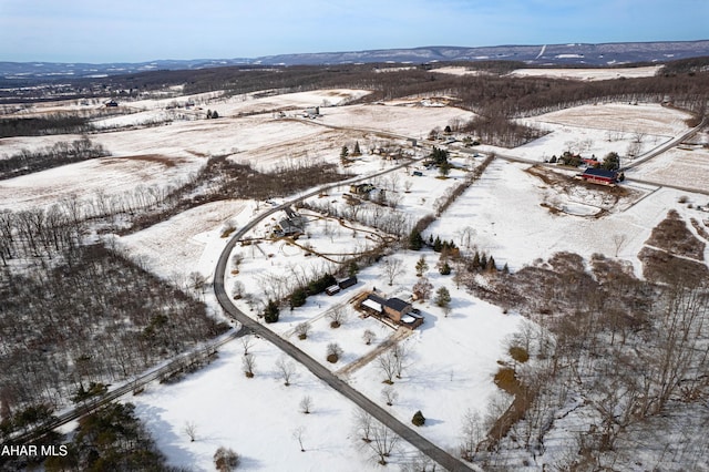 snowy aerial view featuring a mountain view