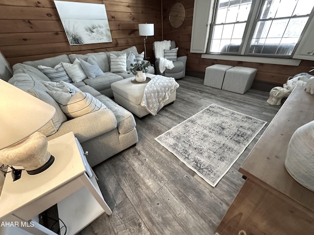 living room with hardwood / wood-style flooring and wooden walls