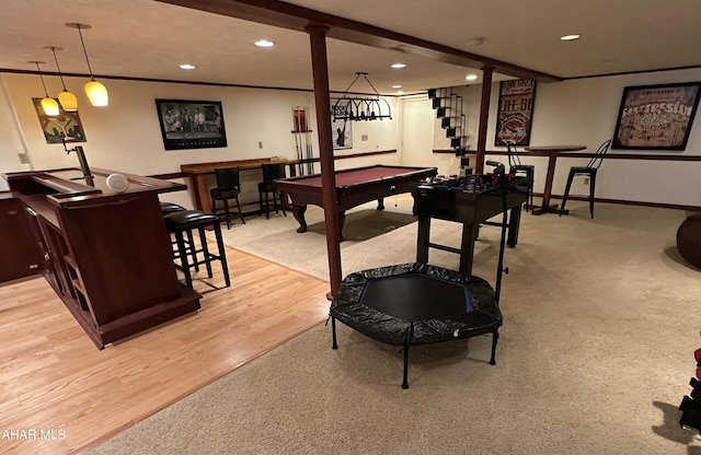 playroom with bar, pool table, and light hardwood / wood-style floors