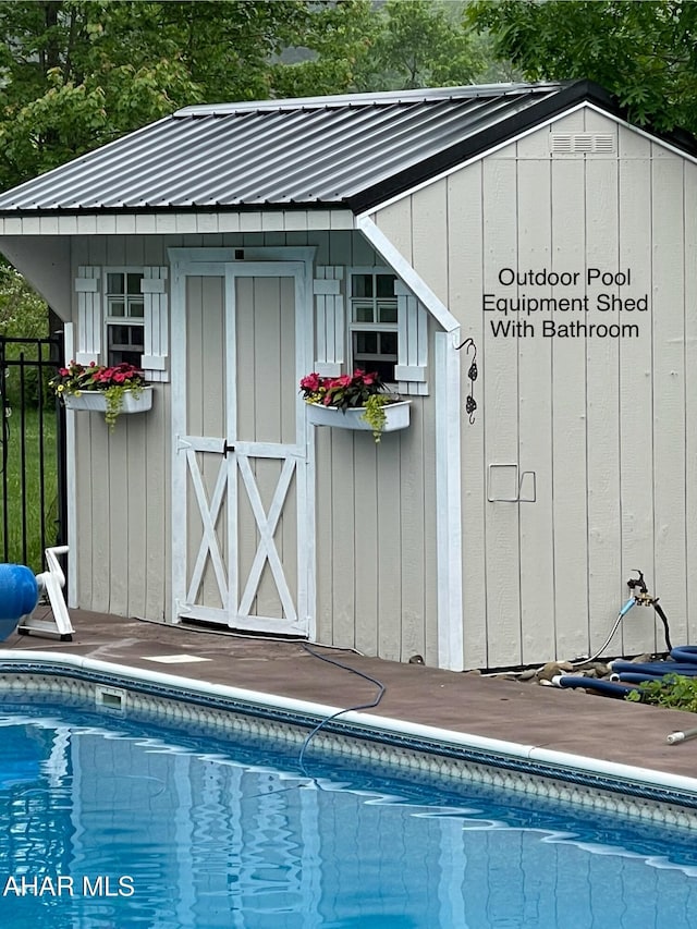 view of outdoor structure with a fenced in pool