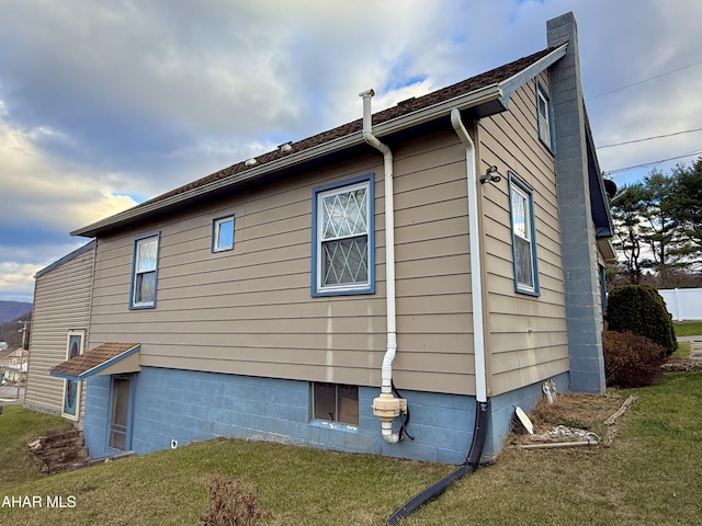 view of side of home featuring a yard