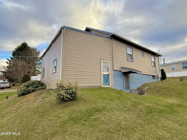 rear view of property featuring a yard