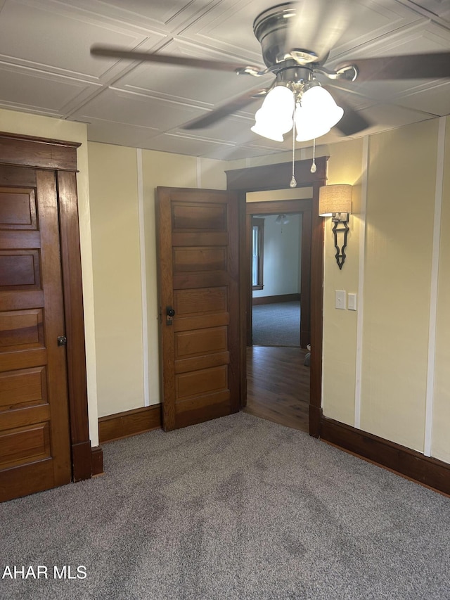 carpeted spare room featuring ceiling fan