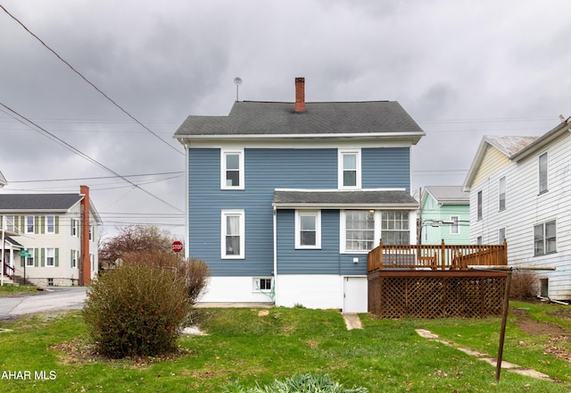 213 N Market St, Martinsburg, PA 16662 - back of property featuring a wooden deck, a lawn, a chimney, and roof with shingles