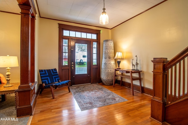 213 N Market St, Martinsburg, PA 16662 - entryway with stairway, light wood finished floors, ornate columns, and ornamental molding