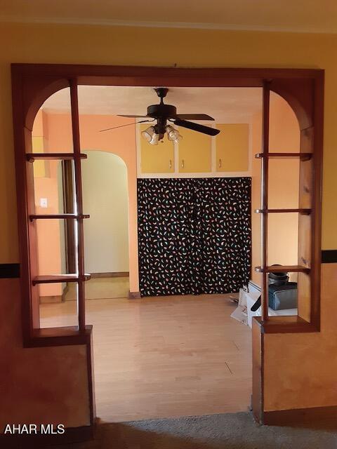 empty room with wood-type flooring and ceiling fan