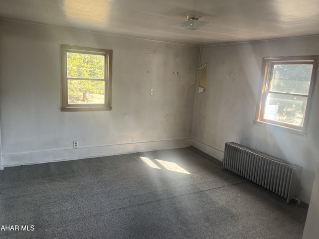 carpeted empty room with radiator