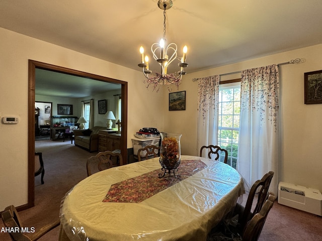 dining area with dark colored carpet and an inviting chandelier