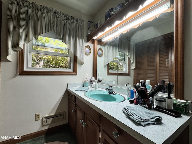 bathroom with plenty of natural light and vanity