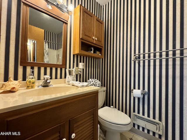 bathroom featuring vanity and toilet