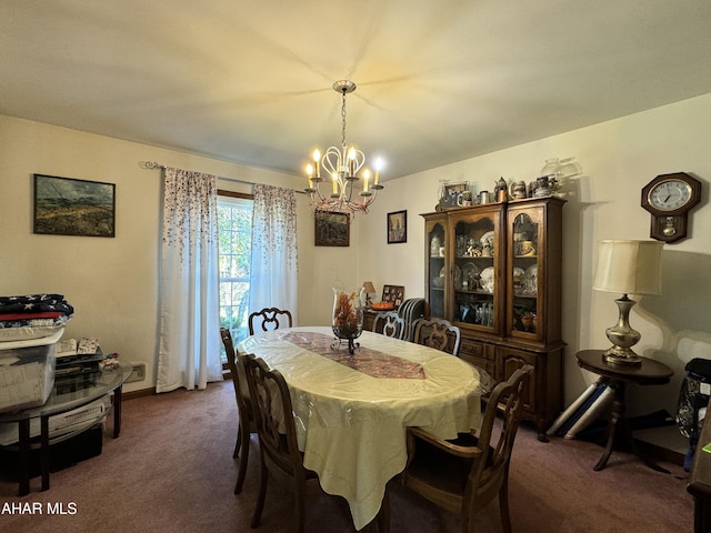 dining area featuring a chandelier and dark carpet