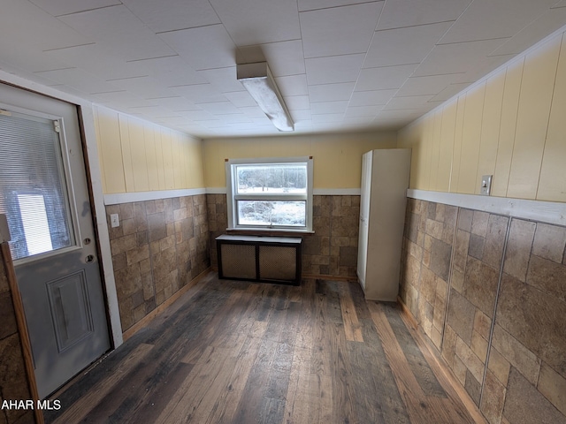 interior space with wainscoting and dark wood-style flooring