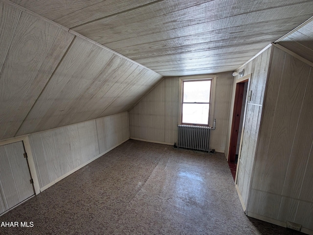 bonus room with vaulted ceiling, radiator, and wood ceiling