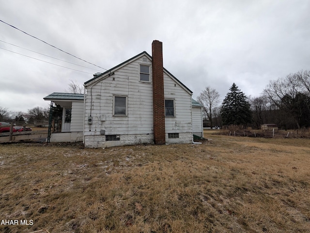 view of side of home with a chimney