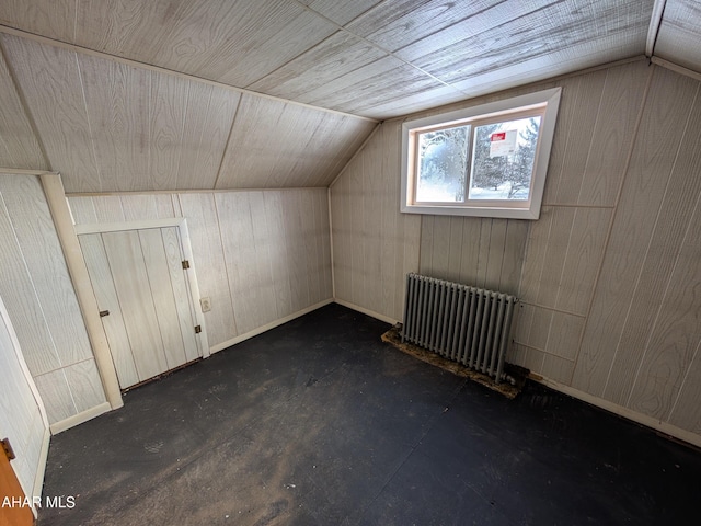 bonus room featuring lofted ceiling, wood walls, and radiator heating unit