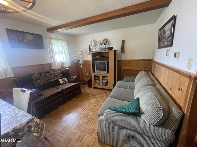 849-853 Fairview Rd, Howard, PA 16841 - living room featuring a wainscoted wall, wooden walls, beamed ceiling, and a textured ceiling