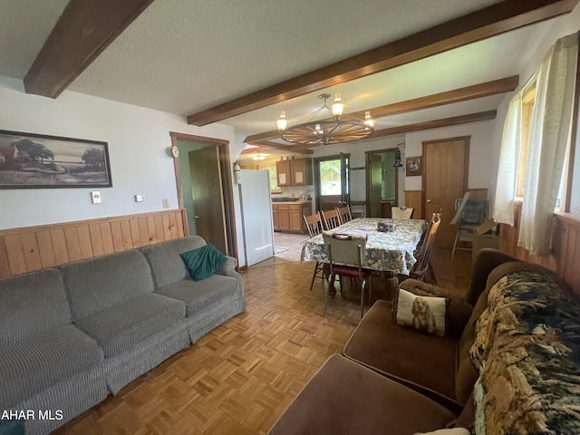 849-853 Fairview Rd, Howard, PA 16841 - living area with beamed ceiling, a chandelier, wainscoting, and wood walls