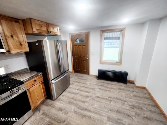 3100 Oak Ave, Altoona, PA 16601 - kitchen featuring light wood-style flooring, baseboards, stainless steel appliances, dark countertops, and radiator