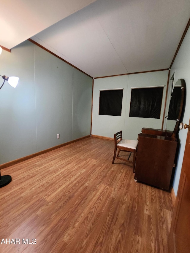 unfurnished room featuring hardwood / wood-style floors and crown molding