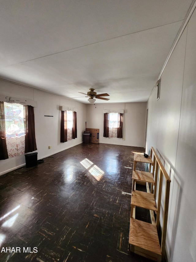 unfurnished living room with ceiling fan