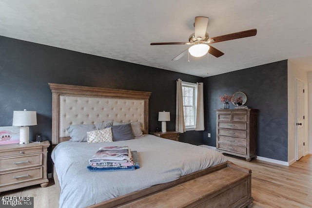 215 Oakwood Dr, Philipsburg, PA 16866 - bedroom with light wood-style floors, a ceiling fan, baseboards, and an accent wall