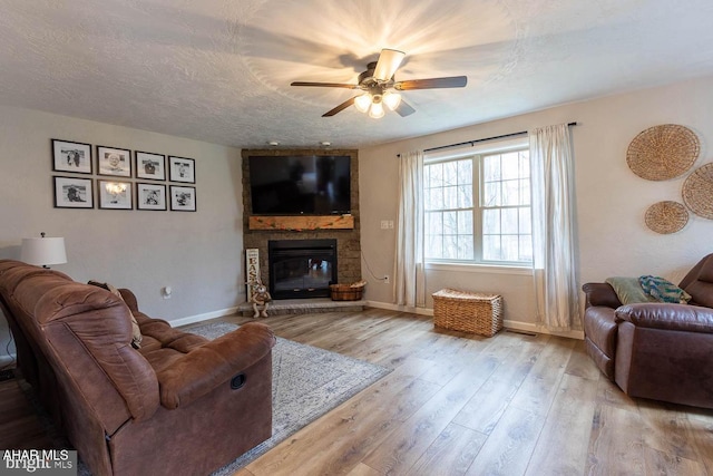 215 Oakwood Dr, Philipsburg, PA 16866 - living room featuring baseboards, ceiling fan, wood finished floors, and a large fireplace