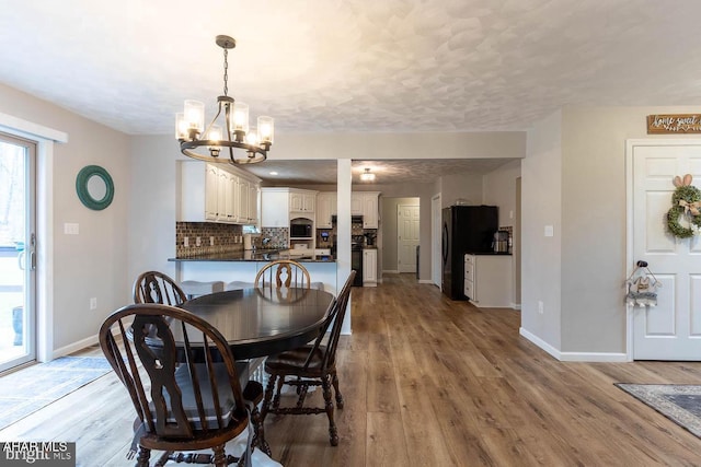 215 Oakwood Dr, Philipsburg, PA 16866 - dining space with baseboards, an inviting chandelier, and wood finished floors