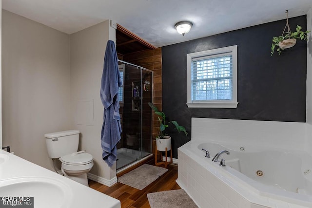 215 Oakwood Dr, Philipsburg, PA 16866 - full bathroom featuring a sink, toilet, a tub with jets, wood finished floors, and a stall shower