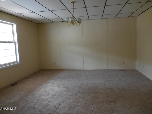 2743 Everett Rd, East Freedom, PA 16637 - empty room with a paneled ceiling, carpet floors, and a chandelier