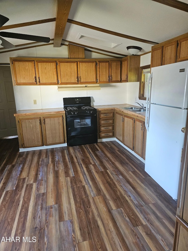 2743 Everett Rd, East Freedom, PA 16637 - kitchen featuring black gas range oven, freestanding refrigerator, brown cabinetry, and dark wood-type flooring