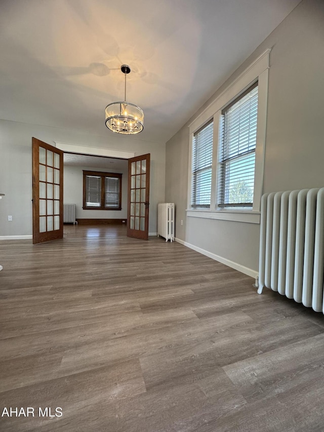 interior space featuring radiator heating unit and wood finished floors