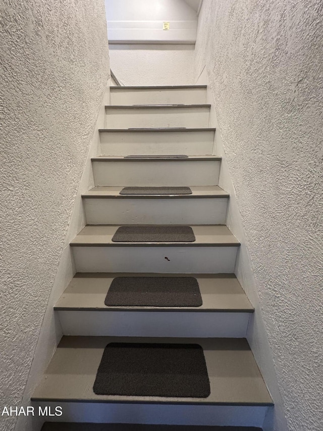 stairs with a textured wall