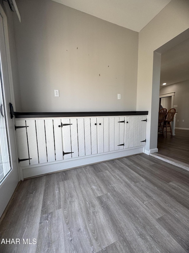 unfurnished room featuring baseboards and wood finished floors