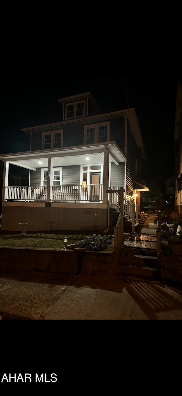 view of back of house at night